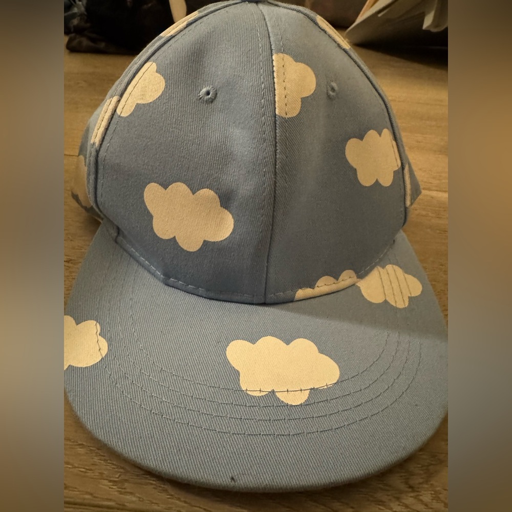 Never worn out, Hat has been in closet, minor staining inside. Blue cloud print